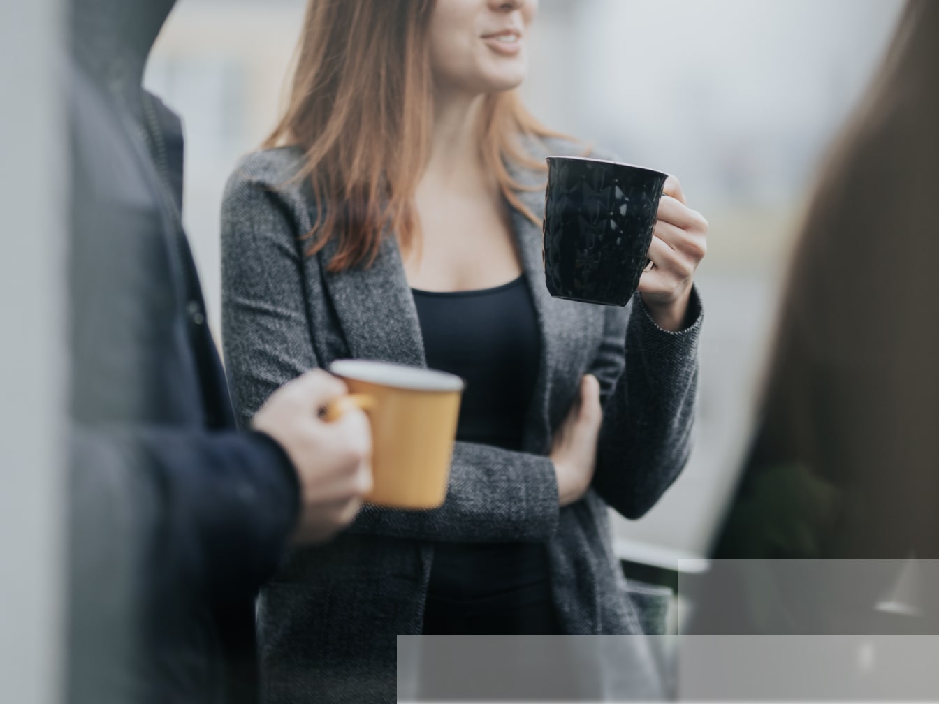 a woman holding a cup of coffee in her hands.